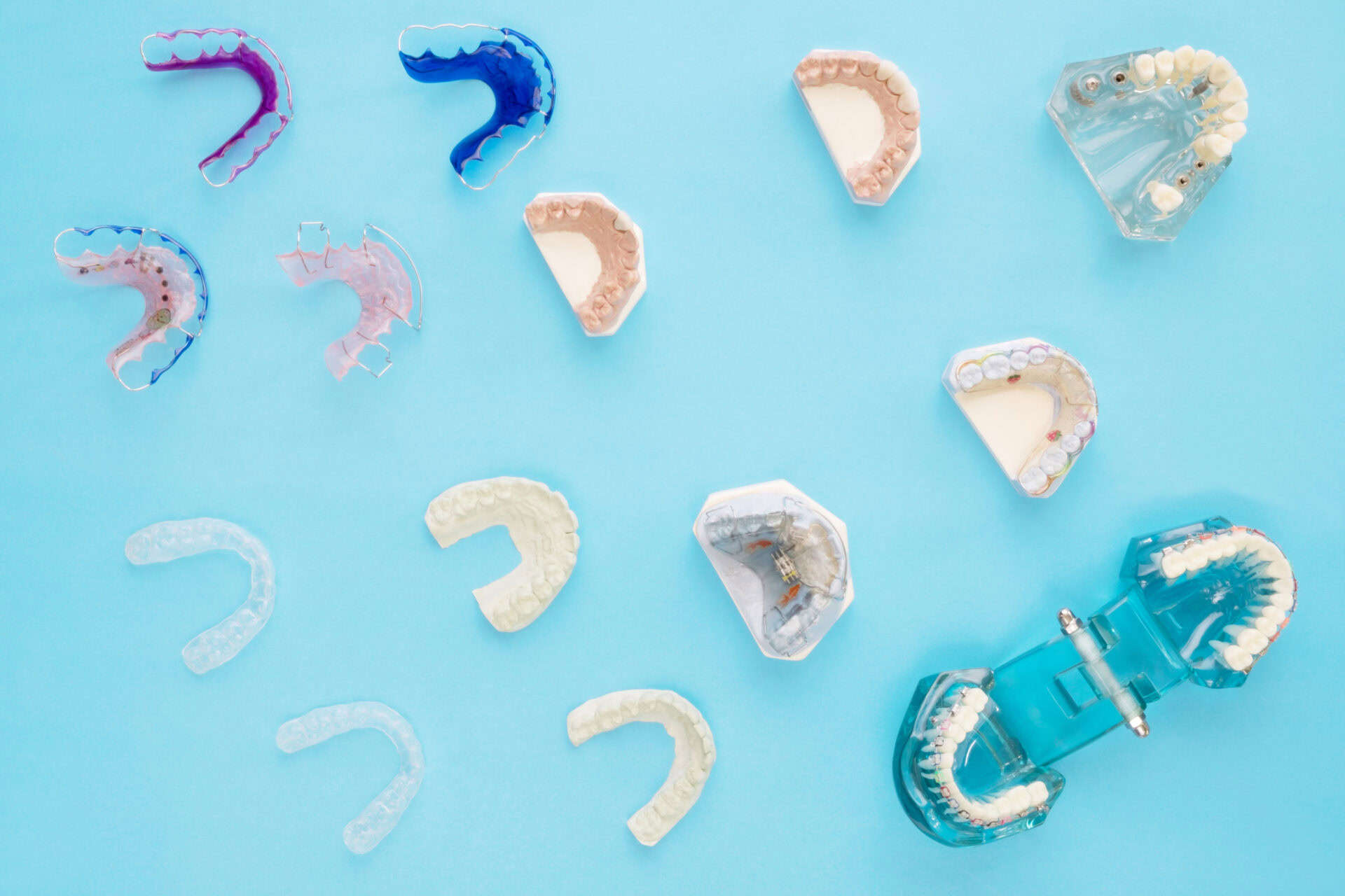 Dental  tools  and retainer orthodontic appliance on the blue background, flat lay, top vipw.